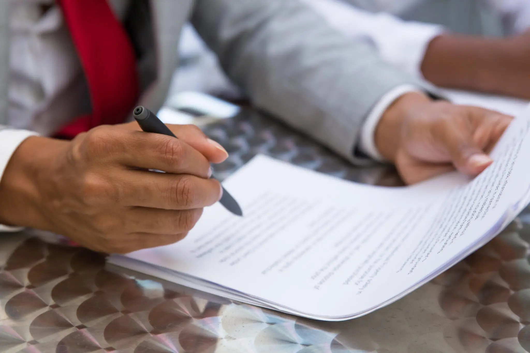 GettyImages-1172407216 Person signing a document with pen.
