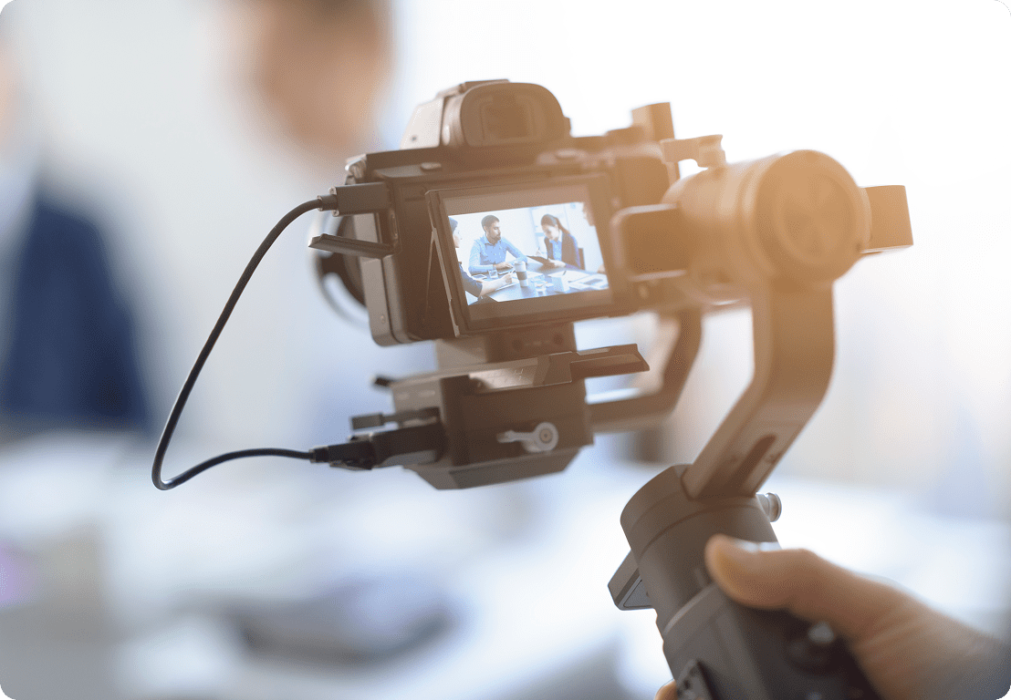 Camera recording two people in a meeting.