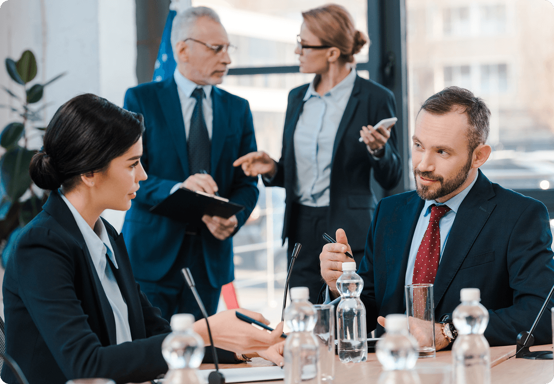 Business meeting with four professionals discussing.