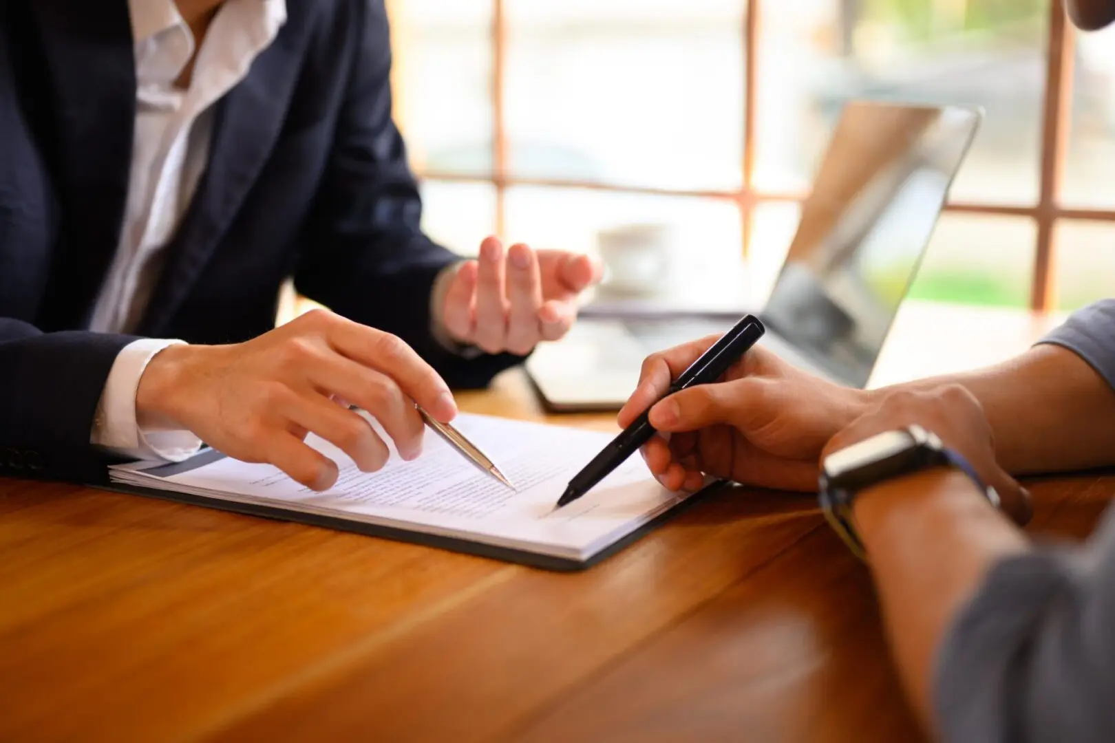 Two people discussing document at desk.